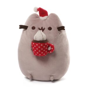 A Pusheen plushie with a cup of cocoa